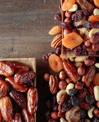 Various dried fruits and nuts in wooden dish.