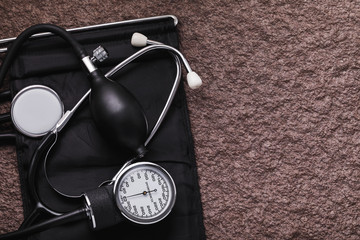 Medical equipment for measuring blood pressure on a stone surface with copy space