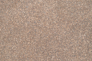 Road surface of small pebbles brown.
