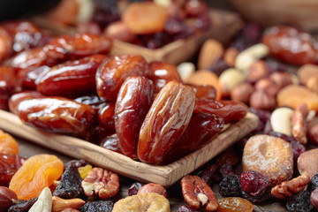 Various dried fruits and nuts in wooden dish.