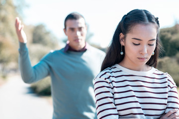 Upset brunette female person bowing her head