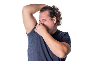 Fat man holds or pinches his nose shut because of a stinky smell or odor. Isolated on a white background