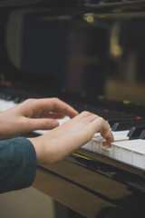Little girl is playing the grand piano.
