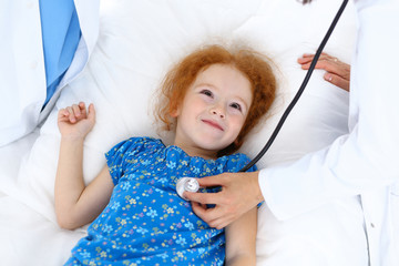 Doctor examining a little girl with stethoscope.Medicine and healthcare concept