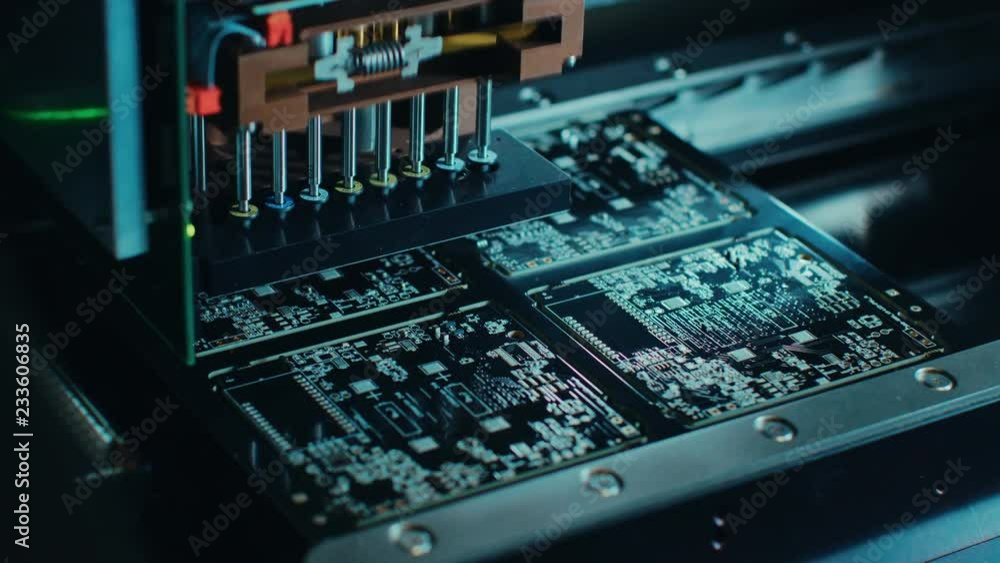 Aufkleber factory machinery at work: printed circuit board being assembled with automated robotic arm, surface