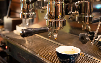 Professional coffee machine making espresso in a cafe