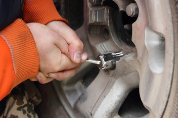 We got a flat tire - the man unscrews the secret nut on the spare wheel - breaks the lock with a...