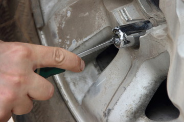 We got a flat tire - the man unscrews the secret nut on the spare wheel - breaks the lock with a...