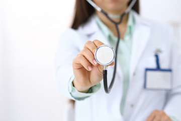 Doctor holds stethoscope head, close-up. Medical help and insurance in health care, best treatment...
