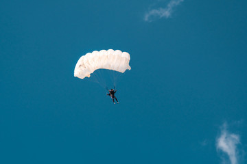 White parachute in blue sky