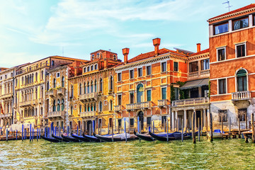 Fototapeta na wymiar Palaces on the shore of Grand Canal and gondolas rent in Venice