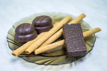 Sweets, pastries on a plate. Waffles, sweet sticks, souffle.