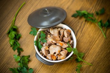 stewed chicken stomachs with vegetables and buckwheat in a bowl
