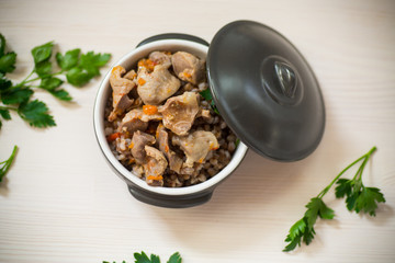 stewed chicken stomachs with vegetables and buckwheat in a bowl