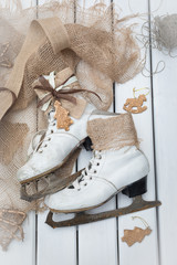 Top view of stages of making Christmas decoration of old vintage ice skates with ribbons