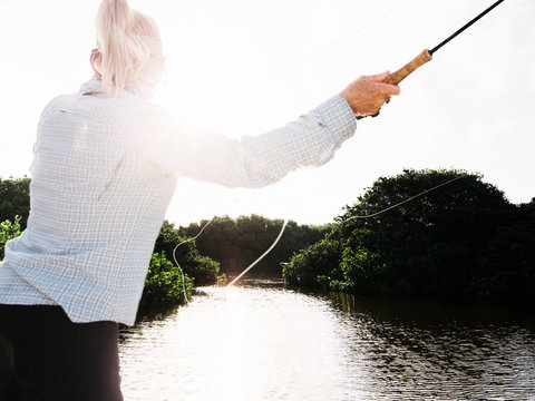 Woman saltwater fly fishing and casting