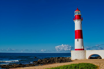 Lighthouse Itapua beach with blue sky, Salvador, Bahia, Brazil                  