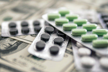 pills in blister on money background