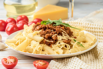 Italian pasta bolognese from pasta penne rigatone minced meat in tomato sauce and parmesan cheese
