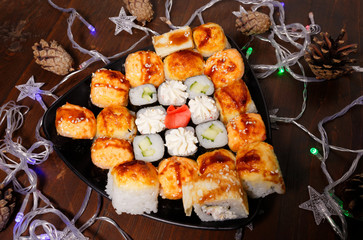 New Year and Christmas Sushi. Beautiful food photo with Christmas garland.