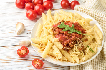 Italian pasta bolognese from pasta penne rigatone minced meat in tomato sauce and parmesan cheese