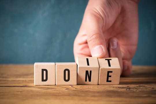 Hand turns two cubes, changing the word "do it" to "done" 
