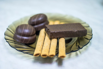 Sweets, pastries on a plate. Waffles, sweet sticks, souffle.