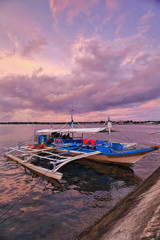 Fototapeta na wymiar Dramatic skies-sunset over tourist balangay or bangka boat. Puerto Princesa-Palawan-Philippines-0754