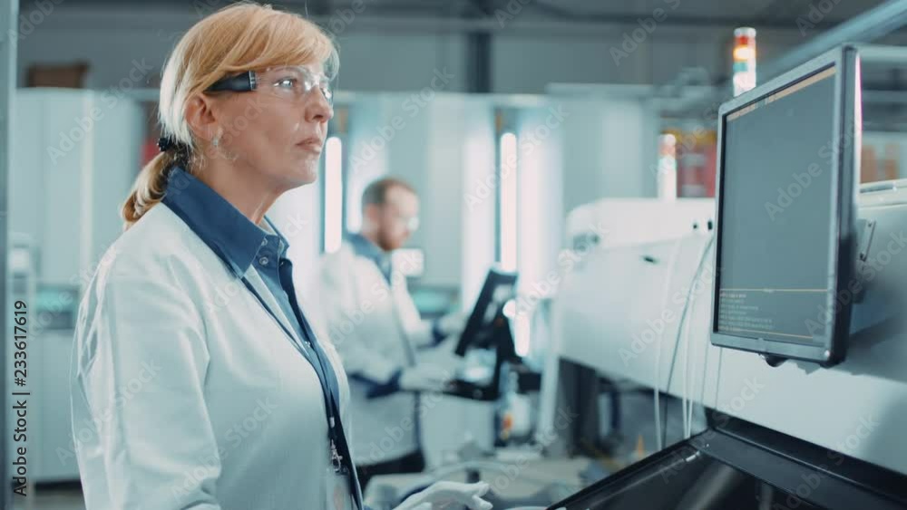 Poster on high tech factory female engineer uses computer for programing pick and place electronic machiner