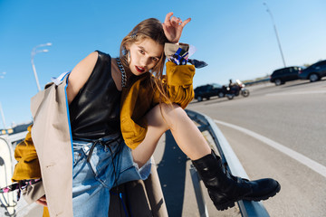 Famous model wearing black leather boots posing outside