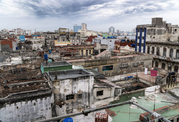 Fototapeta na wymiar Panoramic view over the rooftops of Havana City in Cuba. The run-down buildings mostly in colonial style provide a special flair for visitors and tourists. Panoramic shot of the historical town.