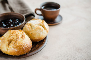 Simple breakfast: coffee americano, fresh buns and jam.