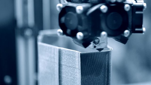 3D printer working close up. Automatic three dimensional 3d printer performs plastic. Modern 3D printer printing an object from the hot molten. Concept progressive additive technology for 3d printing.