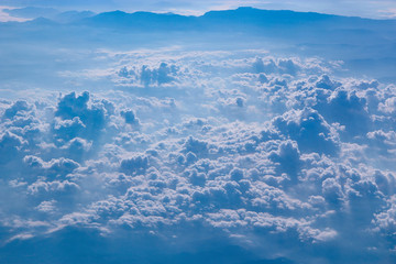 Flight over clouds. Wonderful panorama from window of plane with white clouds