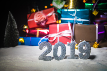 Naklejka premium Christmas gift or New Year with blue ribbon on rustic wood table on bokeh background. Handmade gift concept.