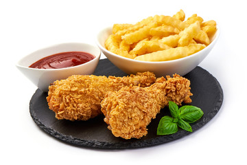 Deep Fried Breaded Chicken Legs (drumsticks) with tomato sauce and french fries, isolated on white background. Close-up.