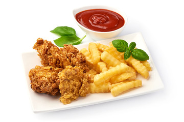 Roasted Breaded Chicken Legs (drumsticks) with tomato sauce and french fries, isolated on white background. Close-up