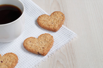 Heart-shaped oatmeal cookies and a cup of coffee