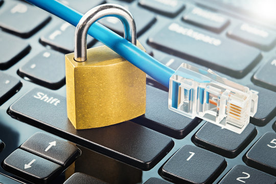 Padlock on computer keyboard with Lan cable. IT and net protection, computer safety. Network Security, data security and antivirus protection PC.