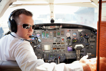 Portrait of pilot sitting in airplane © Cavan for Adobe