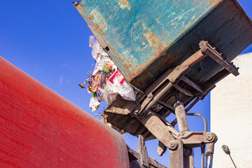 Workers load garbage from the tank in a specialized car garbage truck. A specialized car removes garbage.