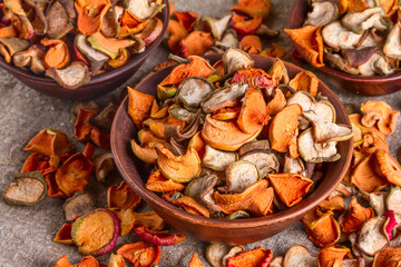 Rural still-life, background - dried fruits from apples and pears in clay bowl close-up, selective focus