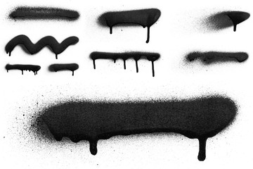 Realistic grunge graffiti spray paint effect on the white wall background. Isolated black ink texture.