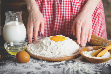 Making dough by female hands at bakery