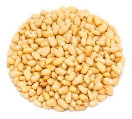 Handful of peeled pine nut kernels, close up, isolated on white background