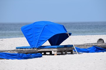 Fototapeta na wymiar Landscape blue relaxing cabana set up on white sand beach resort reserved