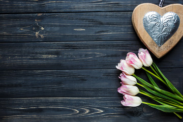 colorful beautiful tulips and decor as a heart on the gray wooden table. Valentines, spring background. floral mock up.  with copyspace. happy mothers day, romantic still life, fresh flowers