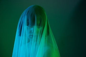 Ghostly green goth girl under fabric