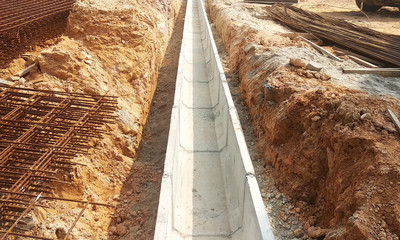 Drainage constructed by construction workers at the constrcution site. The drain used as monsoon drain to channel water to the nearest water pond or river  - obrazy, fototapety, plakaty