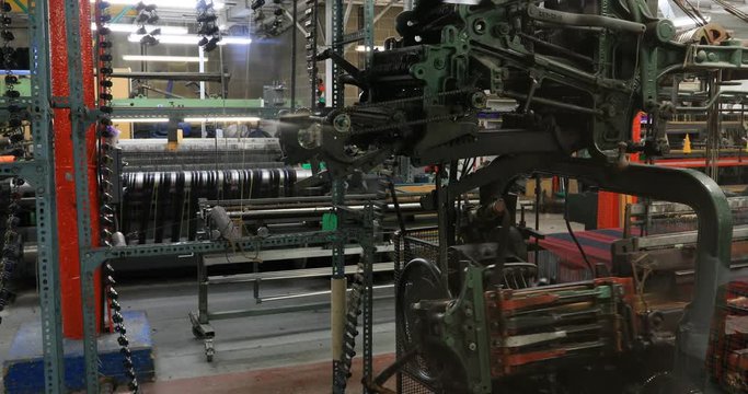 Edinburgh Scotland weave tartar fabric mill. Modern industrial factory and fabric weaver makes historical and authentic cloth for Gaelic traditional dress. Worn during events and Highland Games.